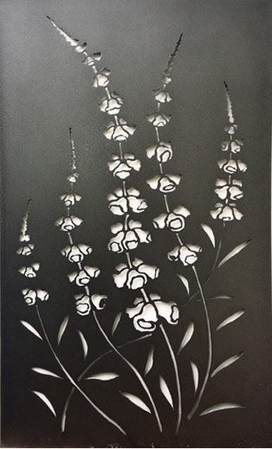 A scene of wildflowers is cut into this metal privacy screen.