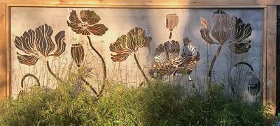 Metal art privacy screen of illustrative and beautiful poppies.